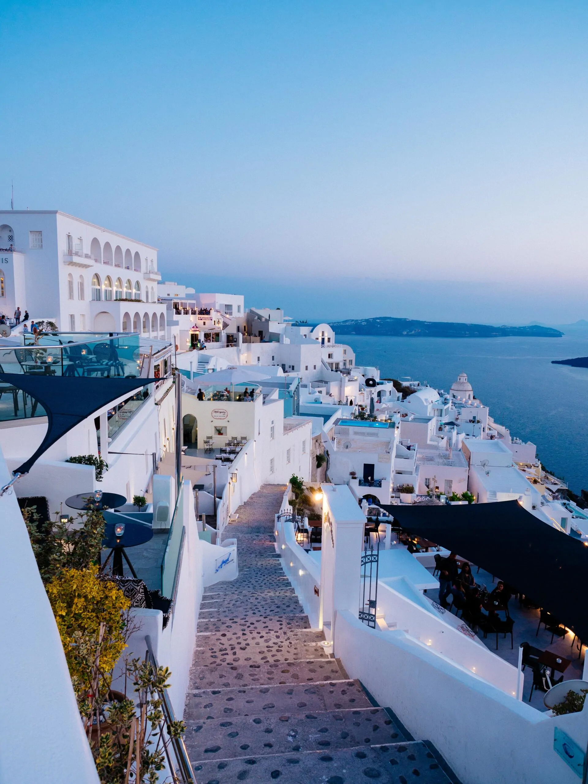 A vertical high angle shot of the white buildings in Santorini, Greece