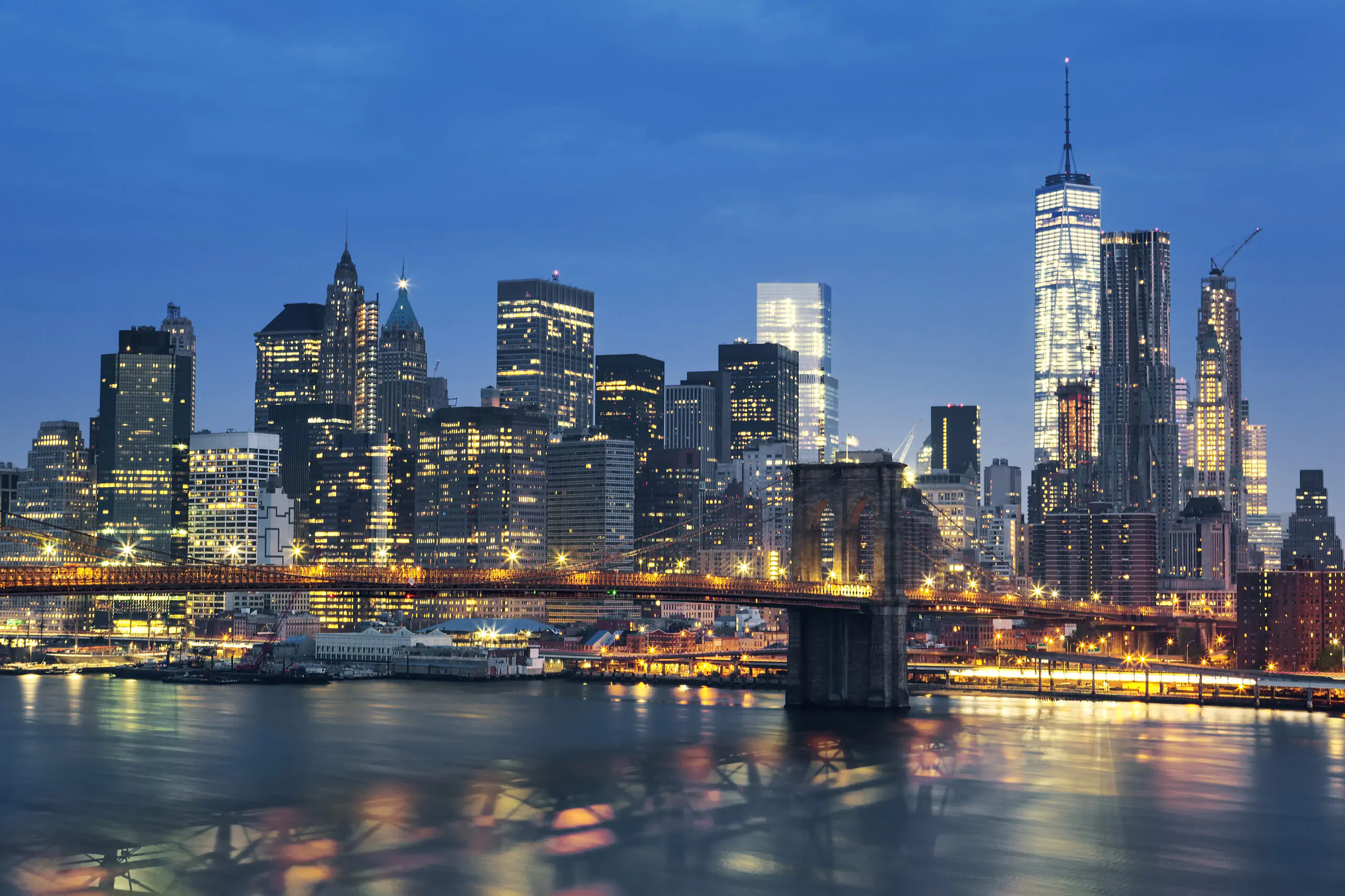 New York City Manhattan midtown at dusk with Brooklyn Bridge. USA.