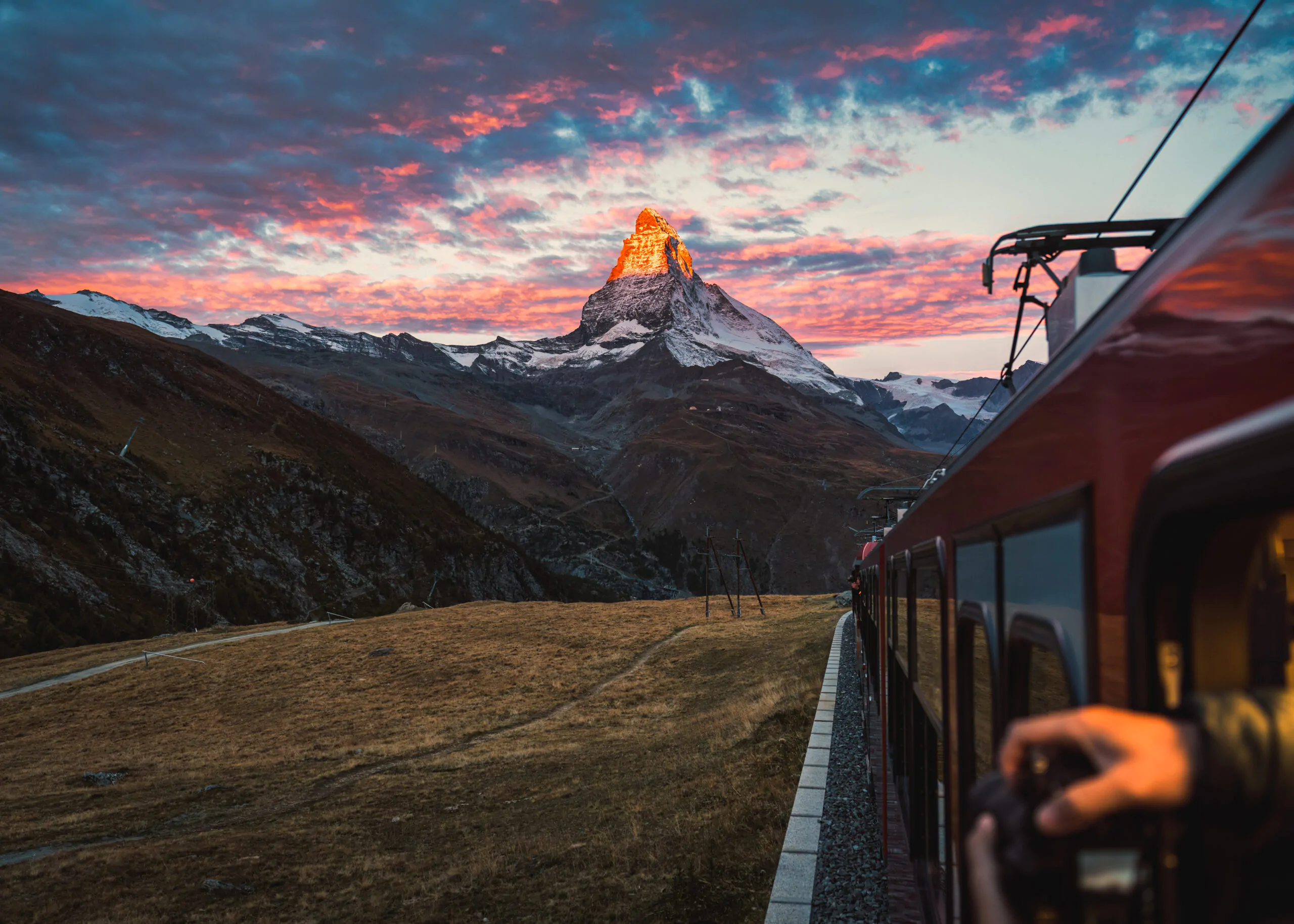 View of sunrise on Matterhorn mountain during the train ride up to Gornergrat station in autumn at Zermatt, Switzerland